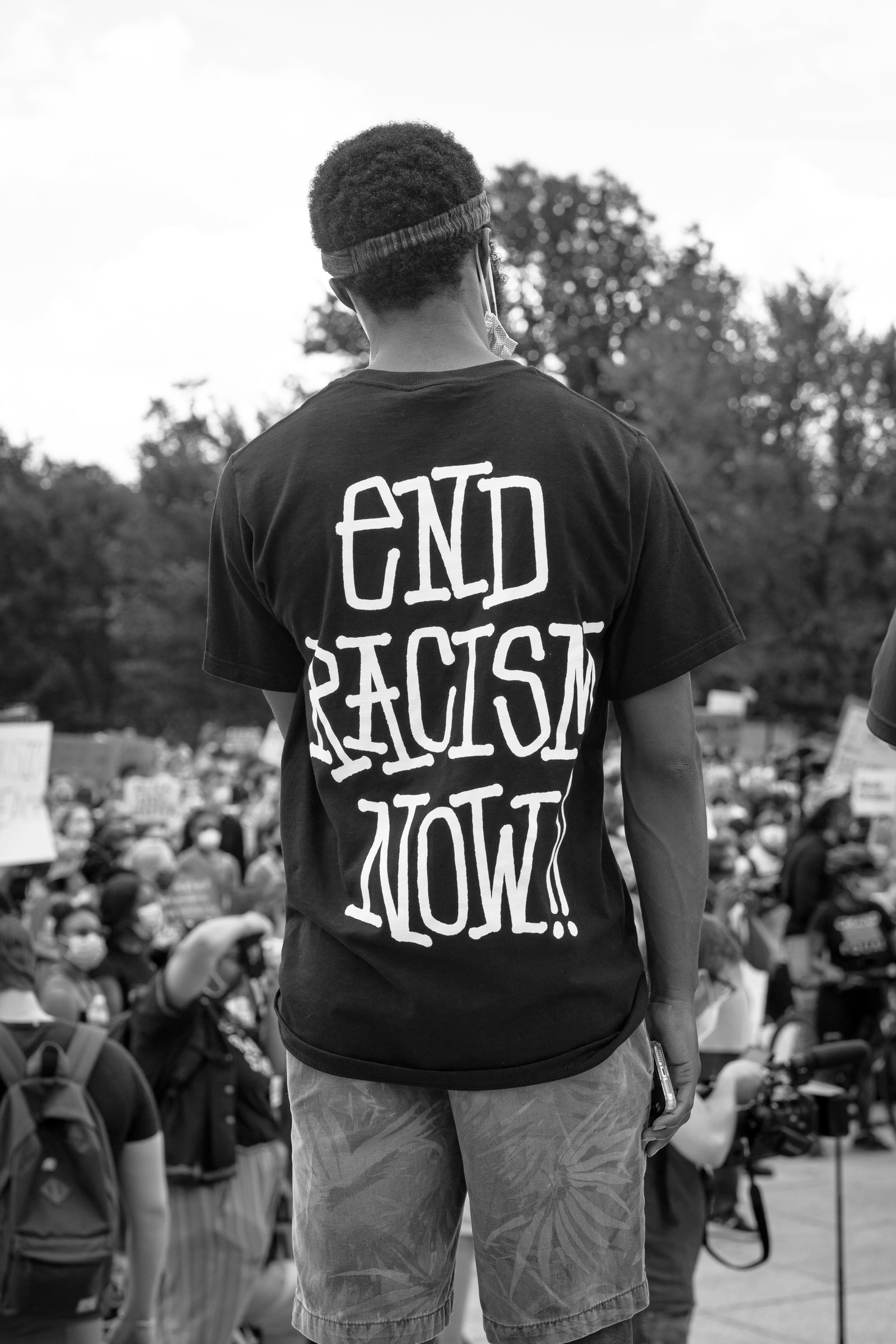 WASHINGTON D.C., UNITED STATES - Jun 19, 2020: Washington D.C./USA-A photo of a Black Lives Matter protester with a shirt reading "end racism now."This photo was taken next to the Lincoln Memorial.